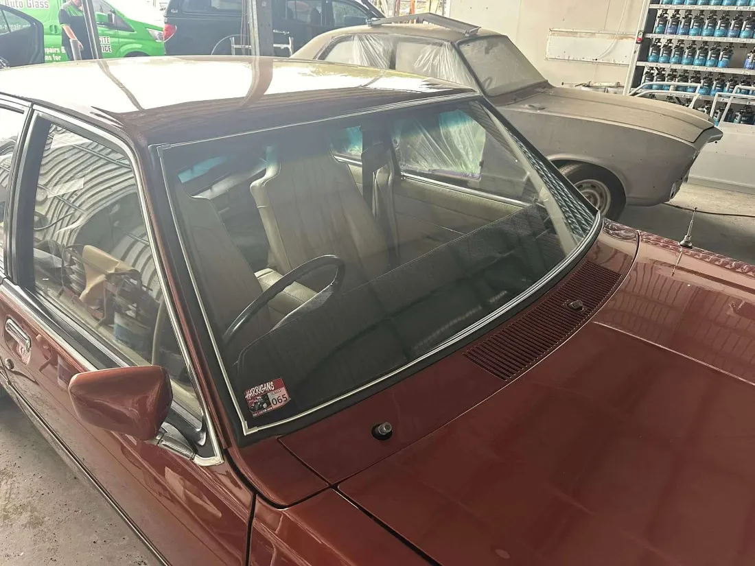 New windscreen set into the rubber gasket of a restored Australian classic
