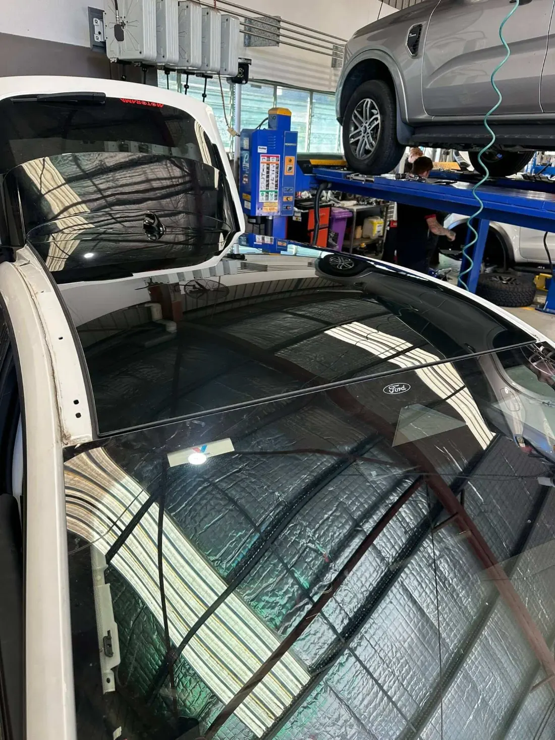 New car windscreen fitted and the trim going back on in the Express Auto Glass workshop