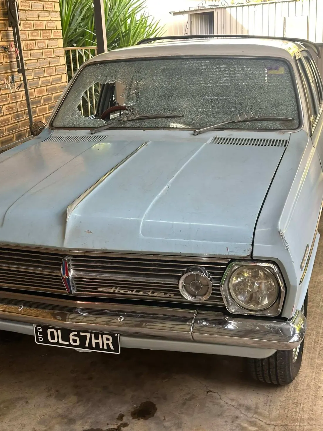 Smashed windscreen on an old Holden sedan