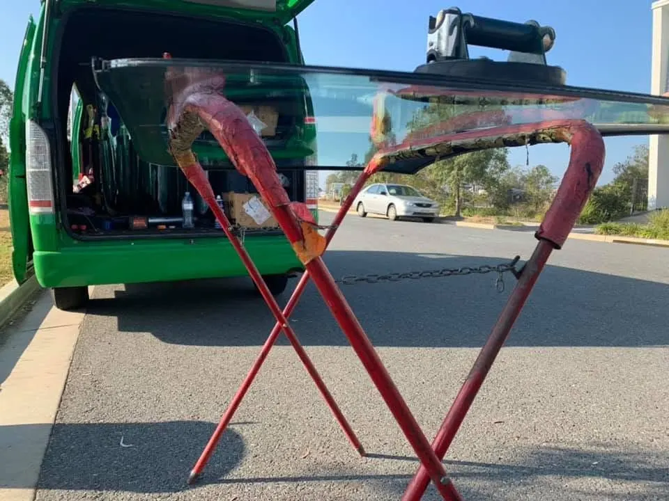 New windscreen on a stand beside the service van on a street