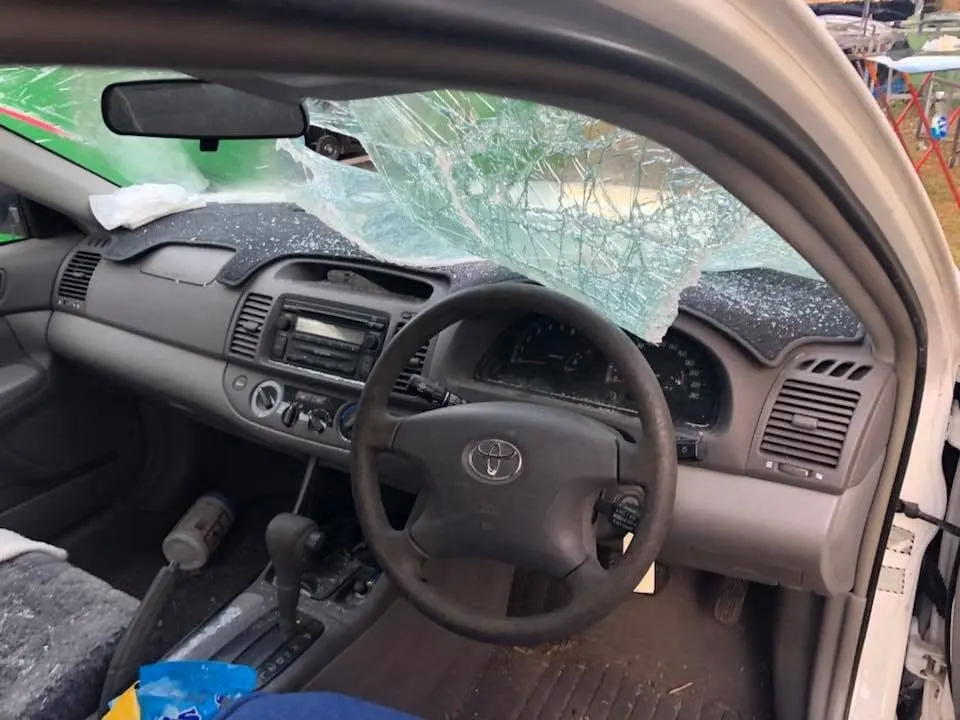 Smashed windscreen seen from inside a family car