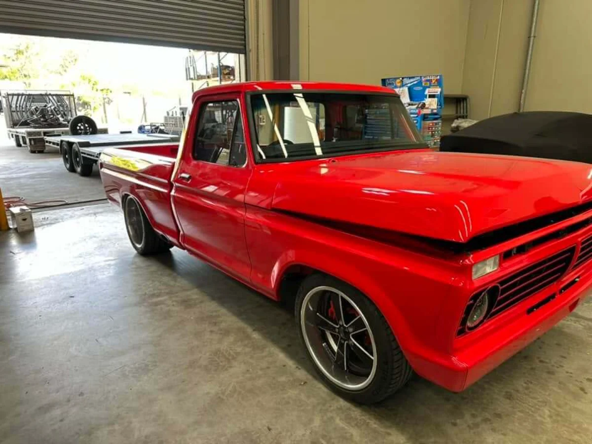 Restored red pickup with a newly fitted windscreen at the Express Auto Glass workshop