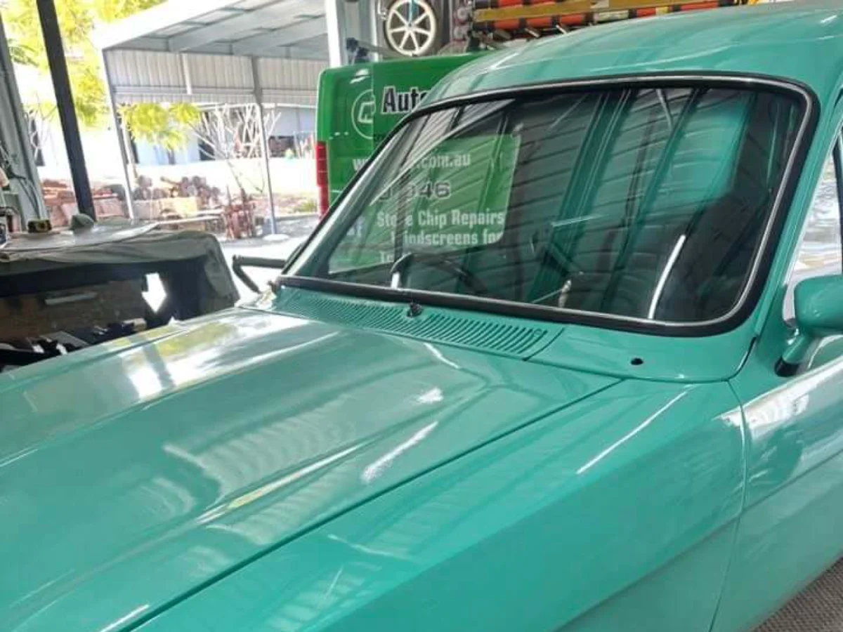 Restored green classic car with a newly fitted windscreen and gasket