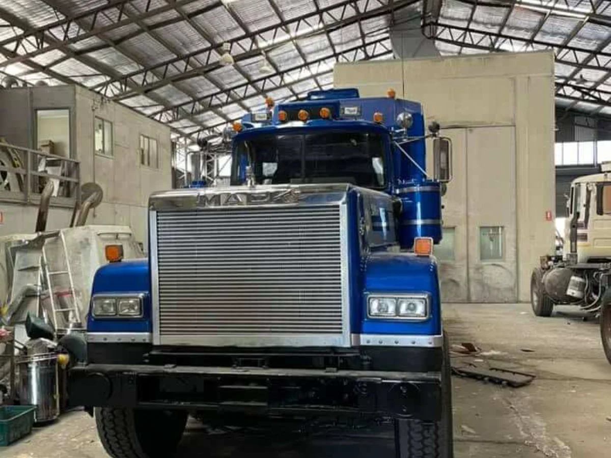 Blue Mack prime mover in the workshop with a new windscreen fitted