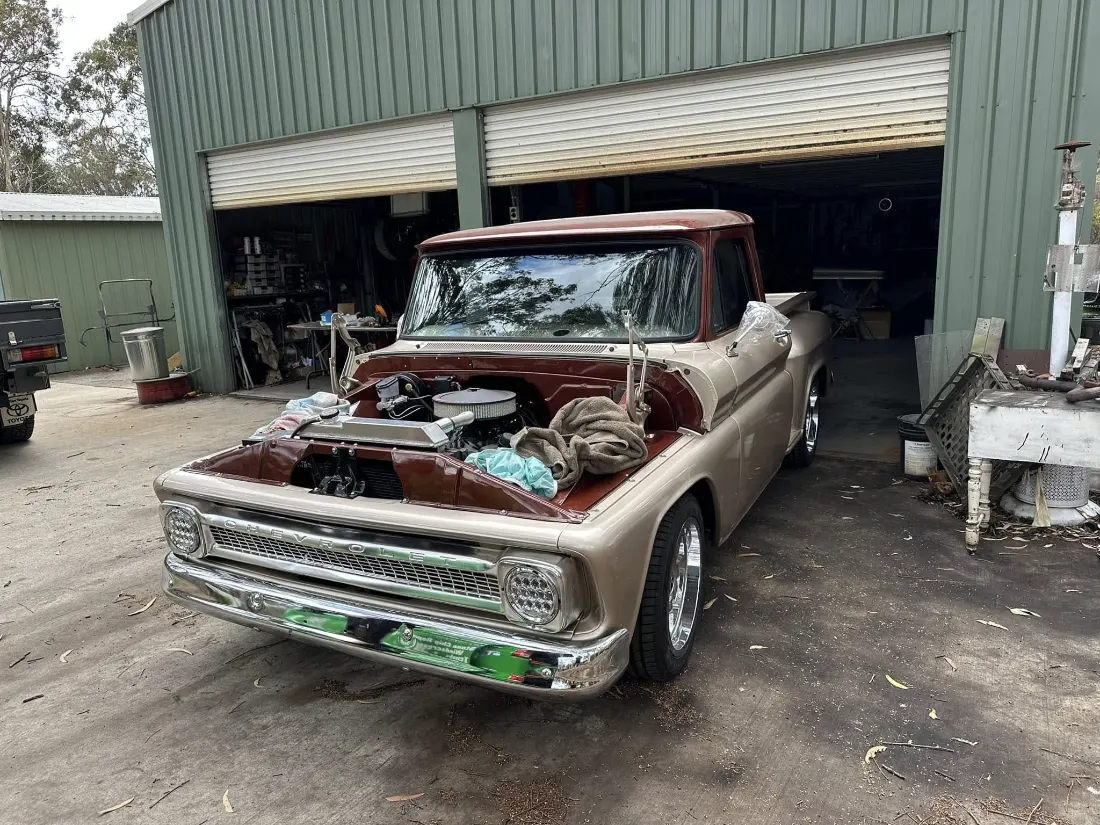 Classic pickup mid-build in a shed after glass work